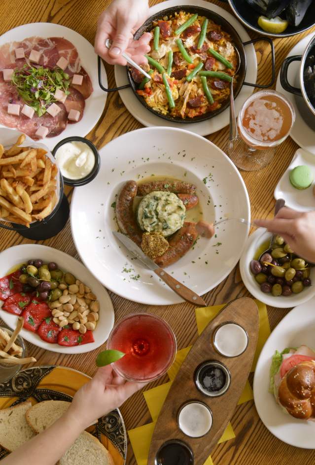 Round wooden table filled with various dishes for Carlisle dining