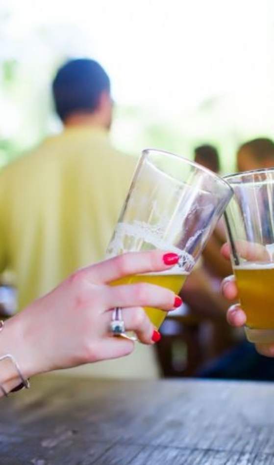 Hands holding pint glasses of beer