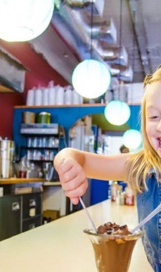 child eating an ice cream sundae