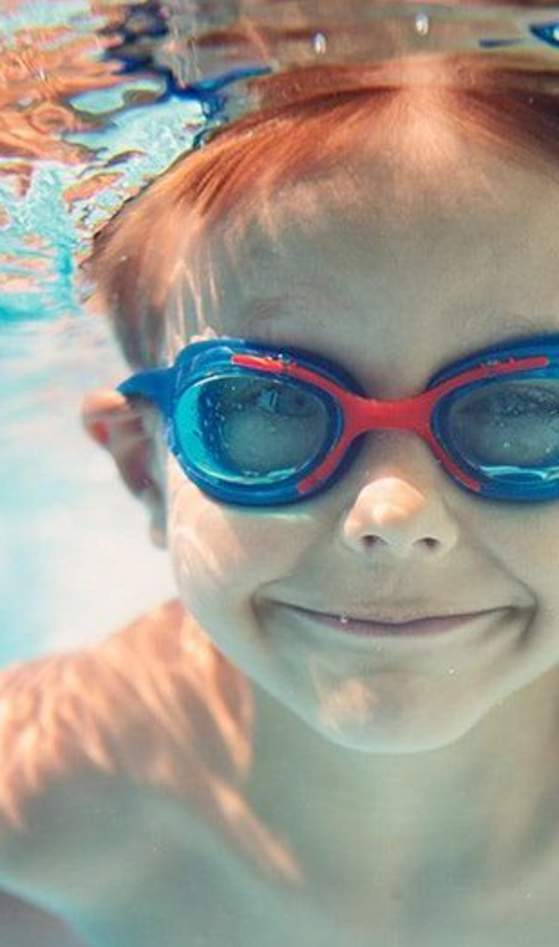 child wearing goggles underwater