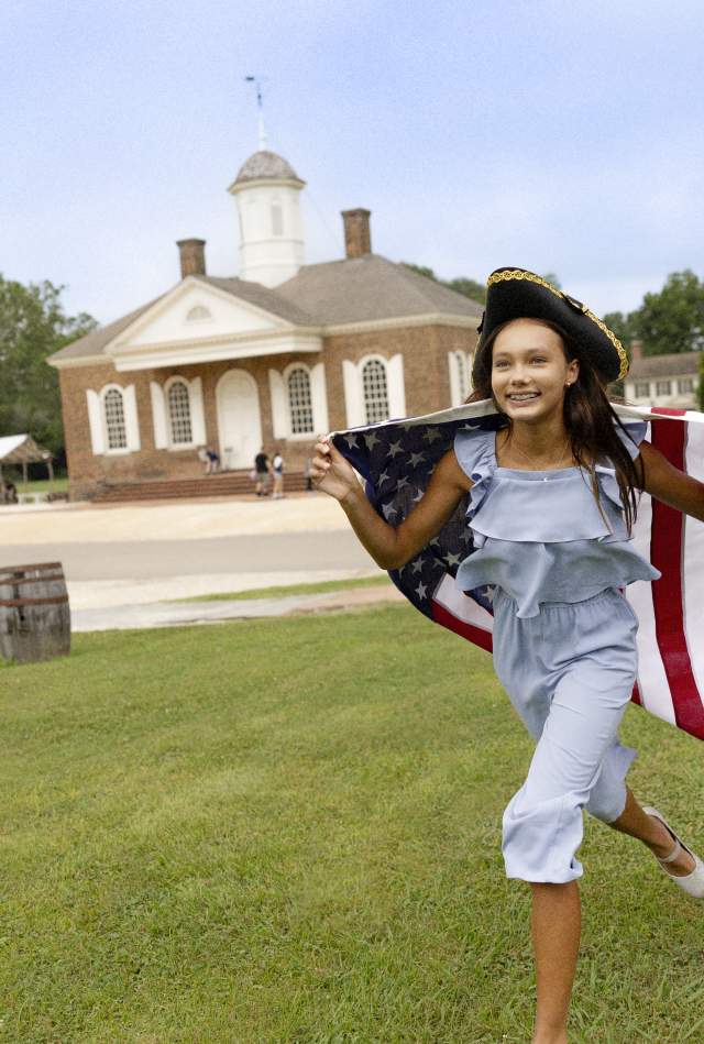 Girl with American Flag Running around Colonial Williamsburg
