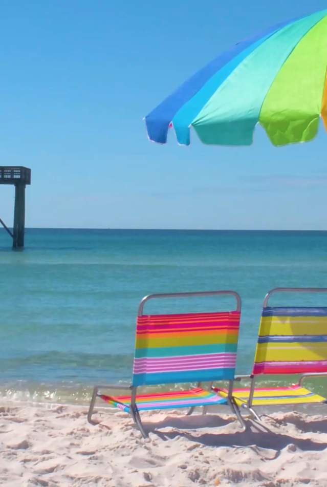 Rainbow umbrella and beach chairs