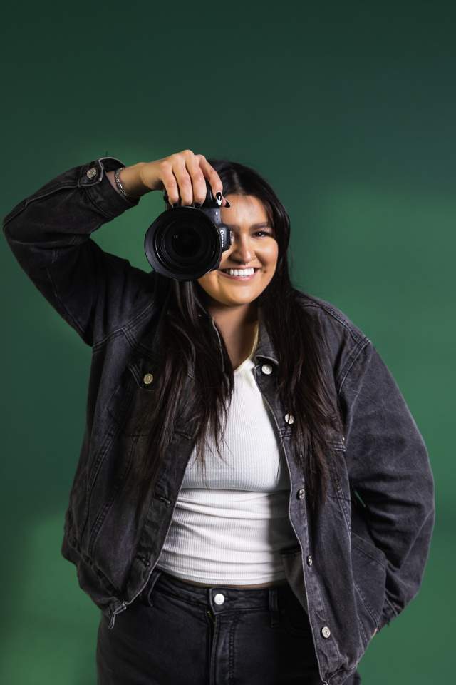 Melani Salazar with Camera on green background