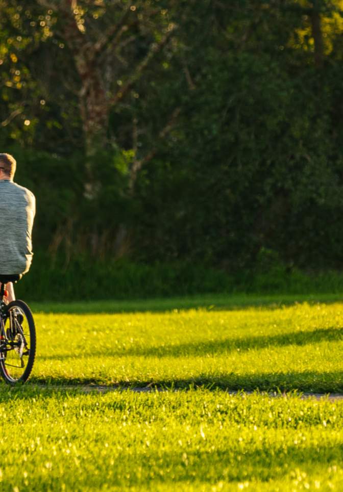 Two visitors ride their bikes through one of Parkland Florida's many beautiful parks