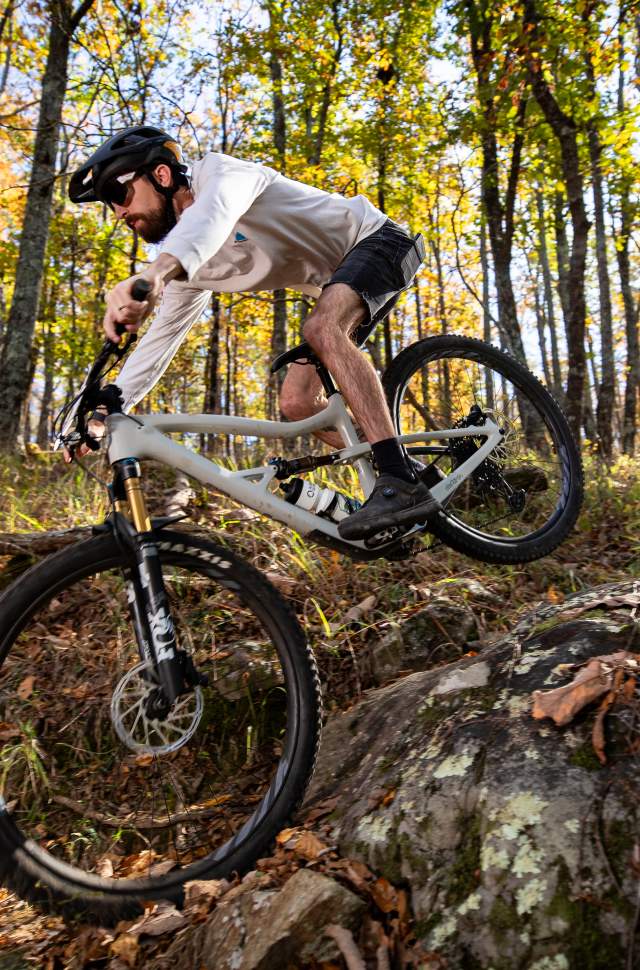 A racer rides his mountain bike over the rocky trails at Oak Mountain State Park.