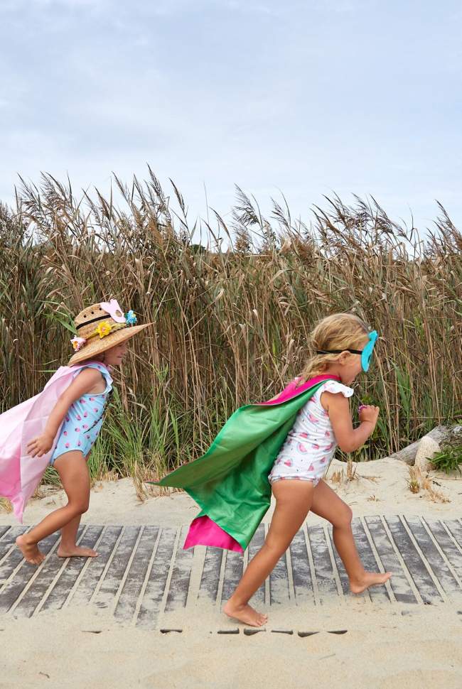 2 girls running on the beach