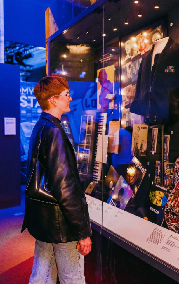 A girl looks inside a cabinet in the British Music Experience