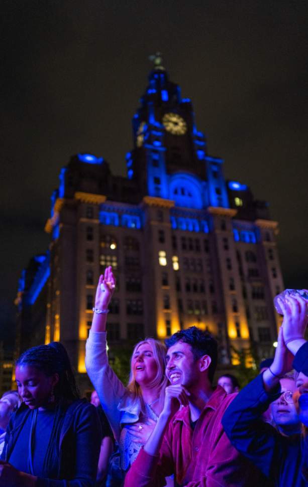 People smiling, at a concert on Liverpool Waterfront