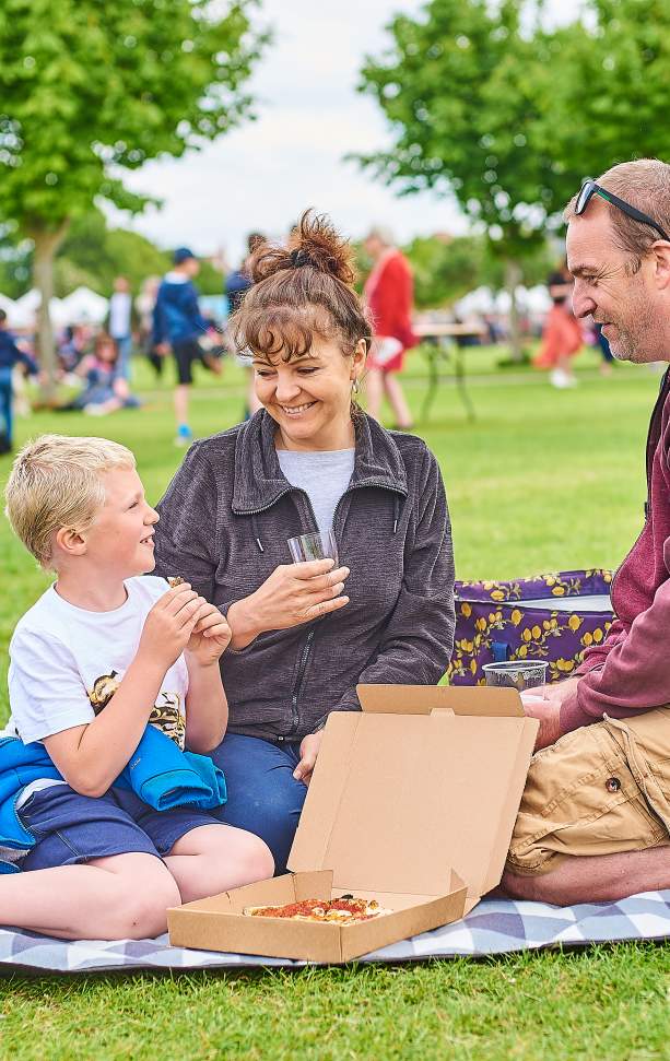 Family enjoying the festival with picnic blanket