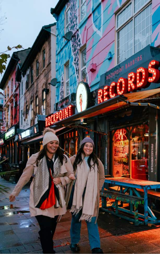 Two girls walk down Victoria Road in New Brighton