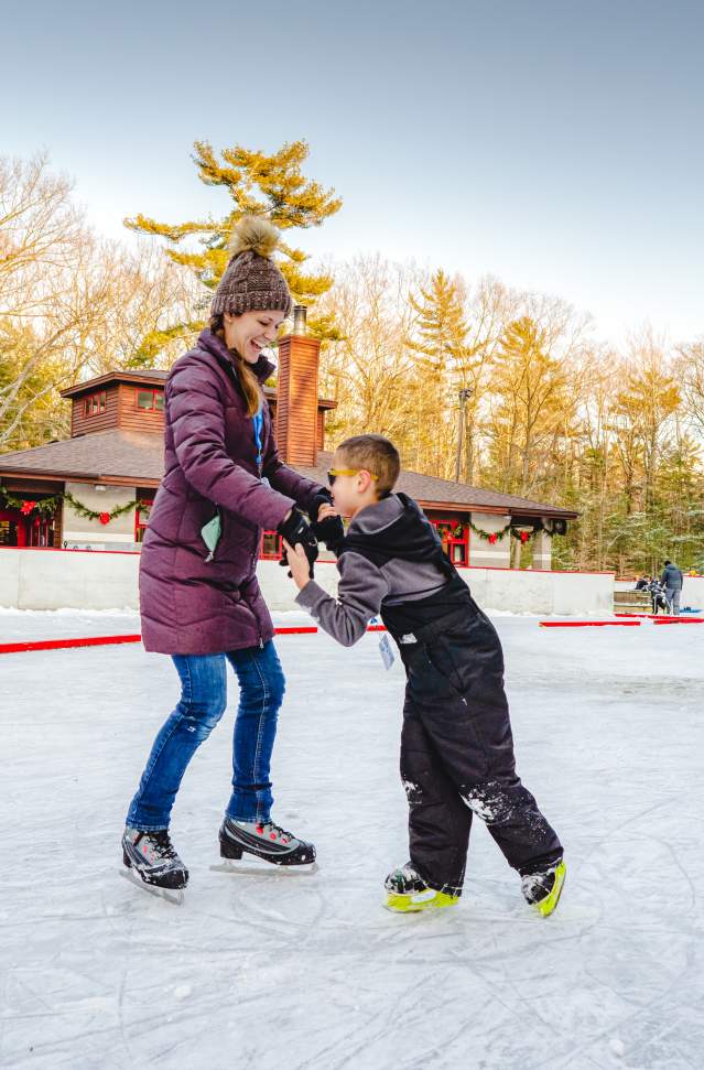 mother & son ice skating on outdoor rink