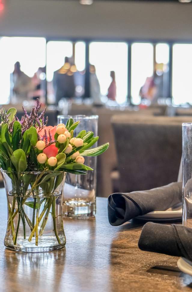 bouquet of yellow and red tulips in vase on table.