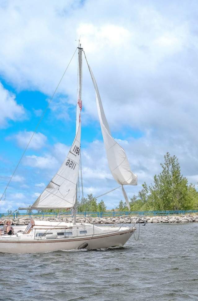 Catamaran sailboat, blue skies with puffy white clouds