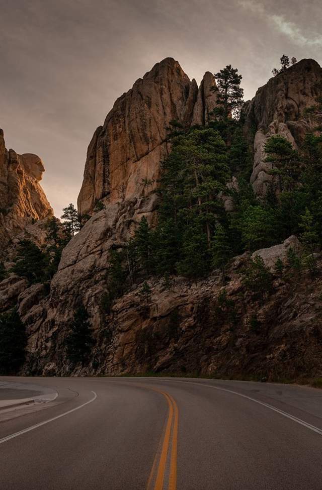 side profile of mount rushmore as you drive past in the black hills of south dakota