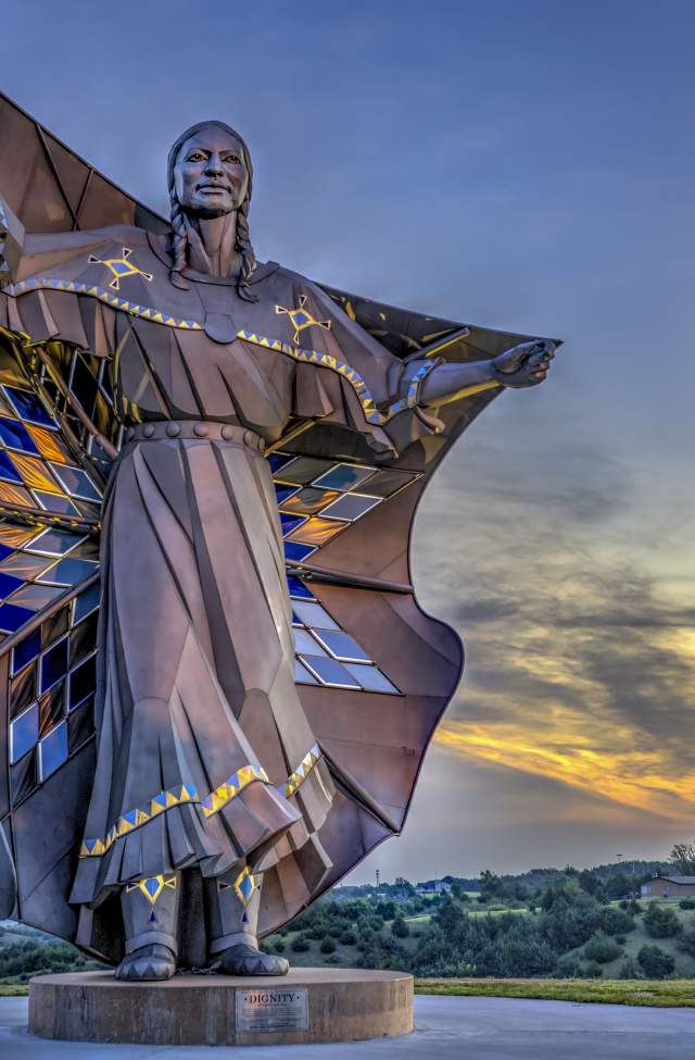 sunset behind the dignity statue found in chamberlain south dakota
