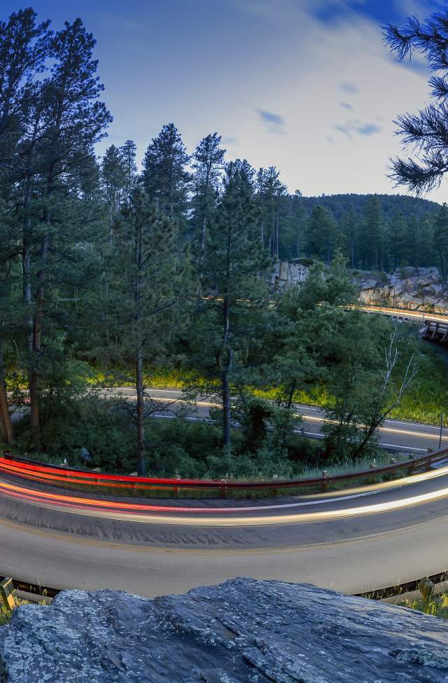 timelapse of car headlights looping around the pigtail curve of peter norbeck scenic byway