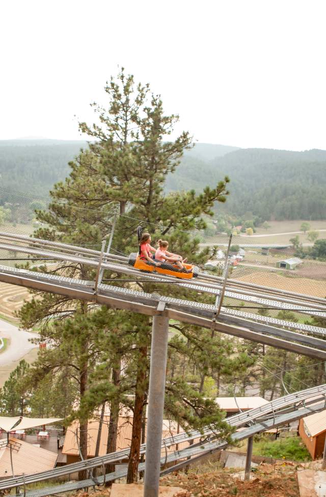 mountain coaster views of the black hills as two riders enjoy rush mountain adventure park