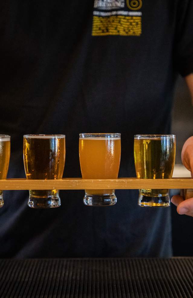 Bartender carrying a flight of beer at a local brewery in Temecula