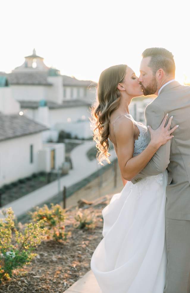 A bride and groom kiss outside Europe Village