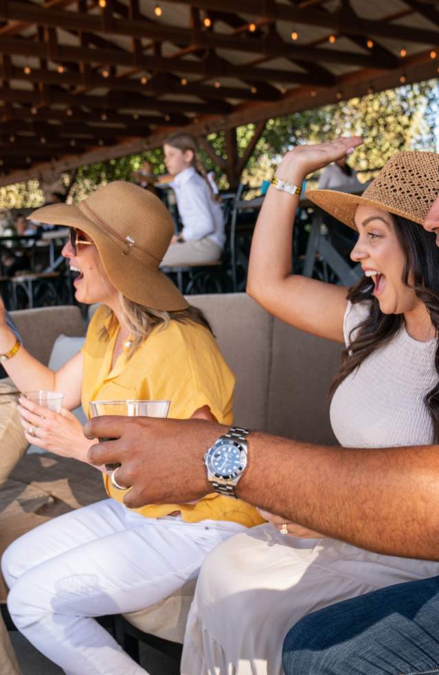 An excited group of friends cheers on the competition at Galway Downs