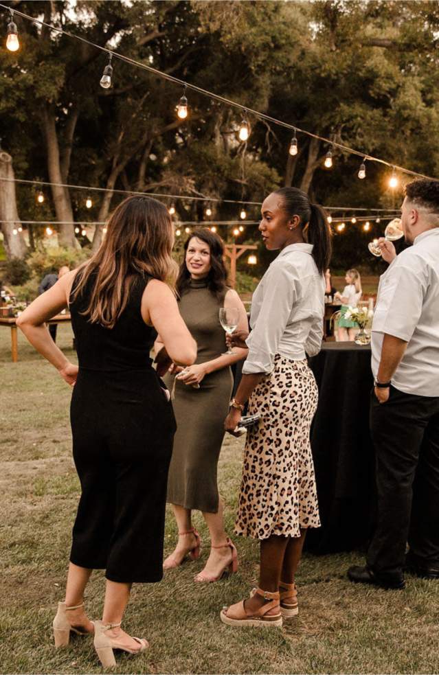 Outdoor meeting reception with high top tables and oak trees