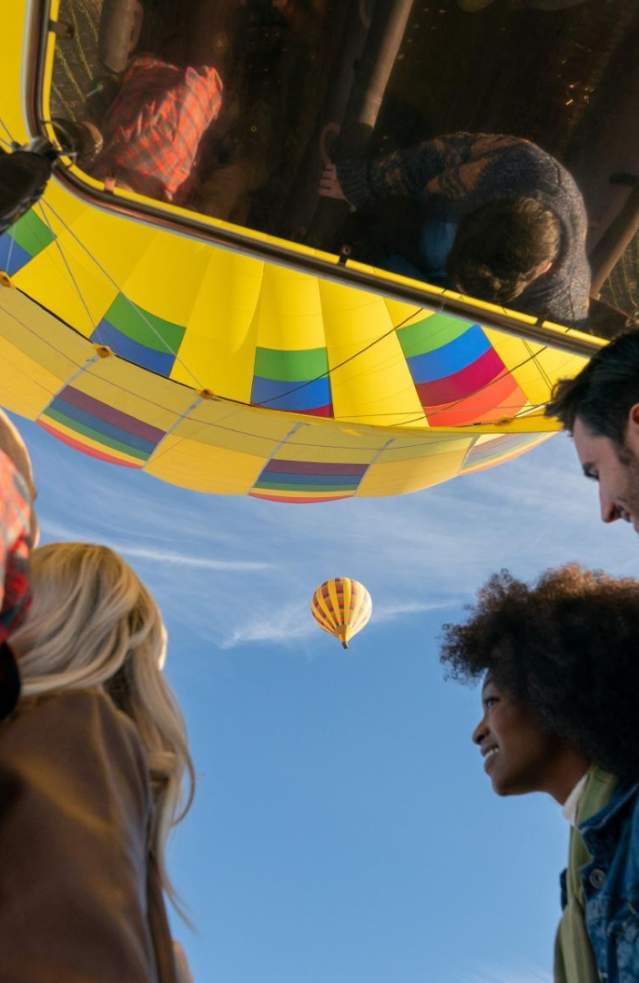Close up of two couples riding a hot air balloon