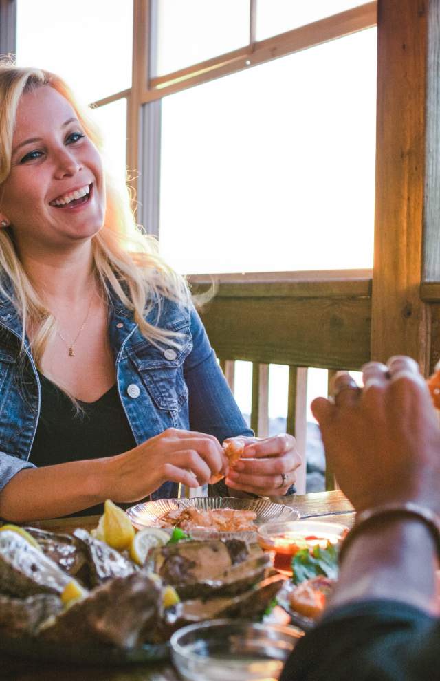 A couple eating seafood on an outdoor patio