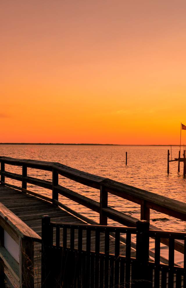 Pier extending into the James River at sunset