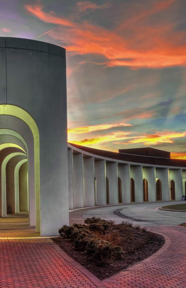 The Ferguson Center for the Arts columns with a sunset