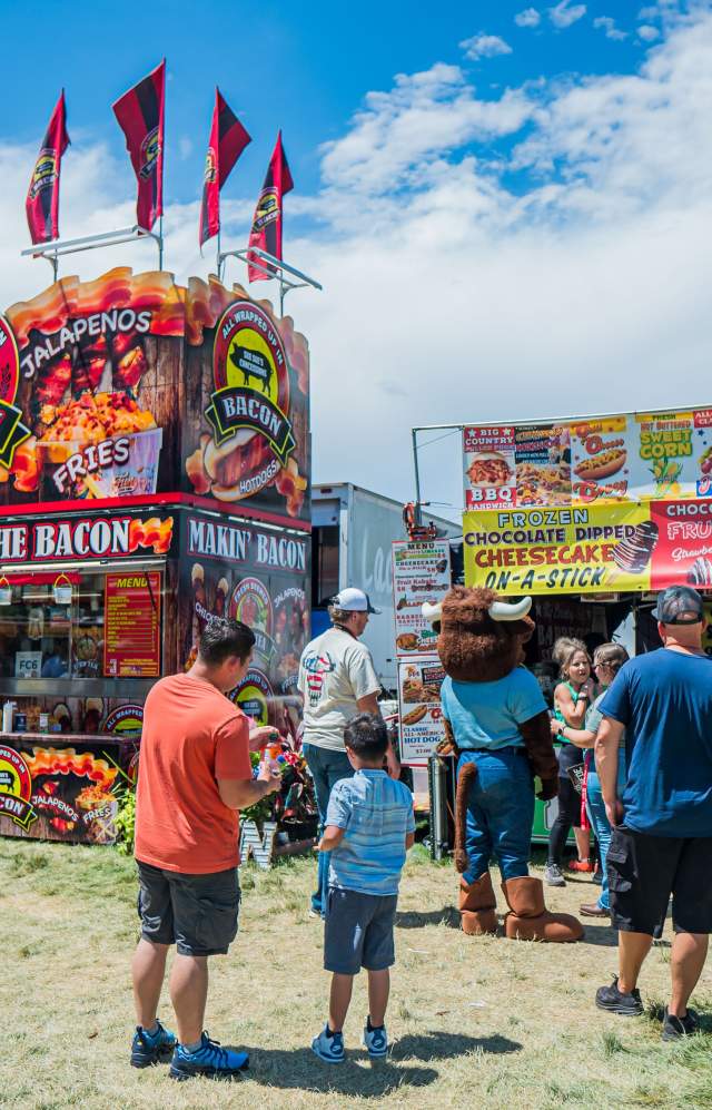 Food vendors with a line of people at the Weld County Fair