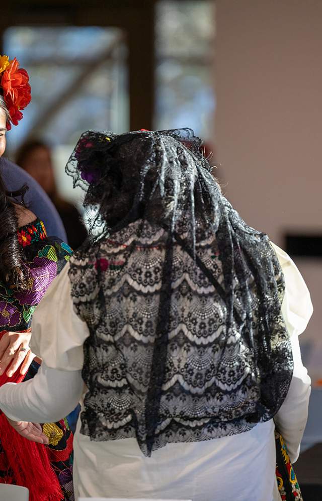 Photo by Robert Lujan of performer Azanet Rodriguez greeting guests at Día de Los Muertos