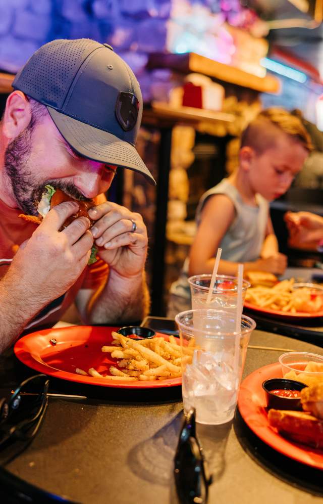 Dad eating a burger with his family at a restaurant in Greeley