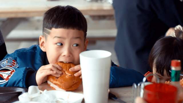 Kid eats burger