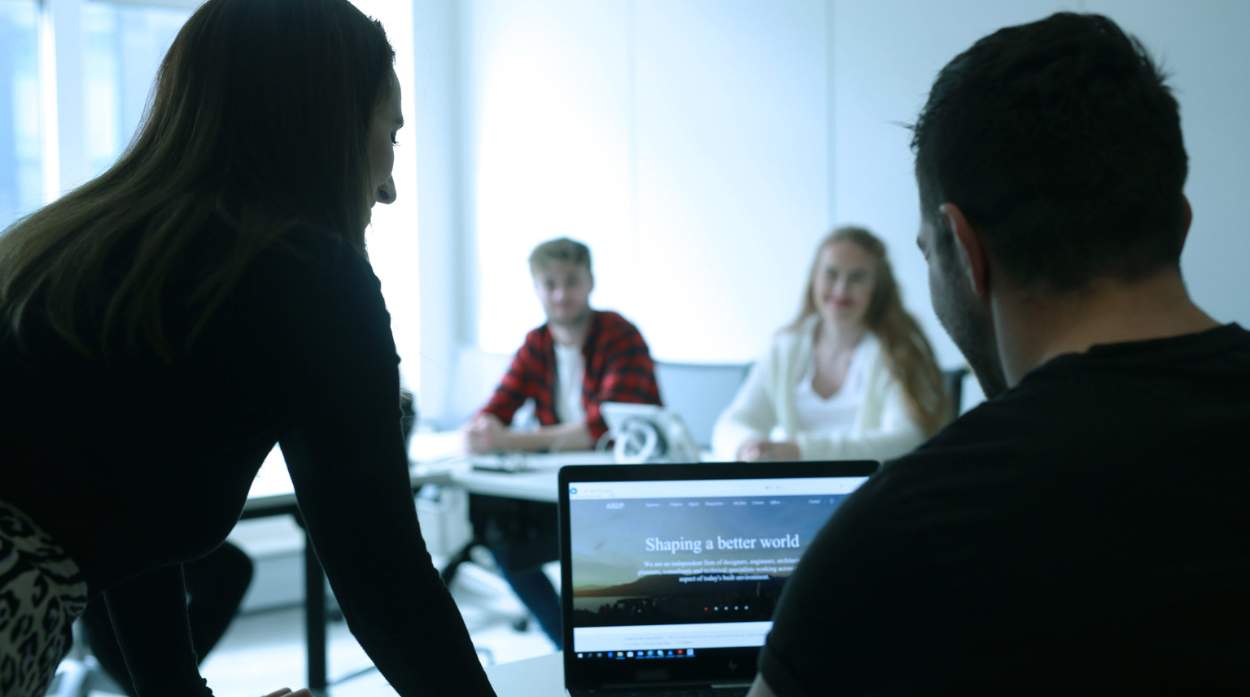 Group of people doing some research on a laptop.