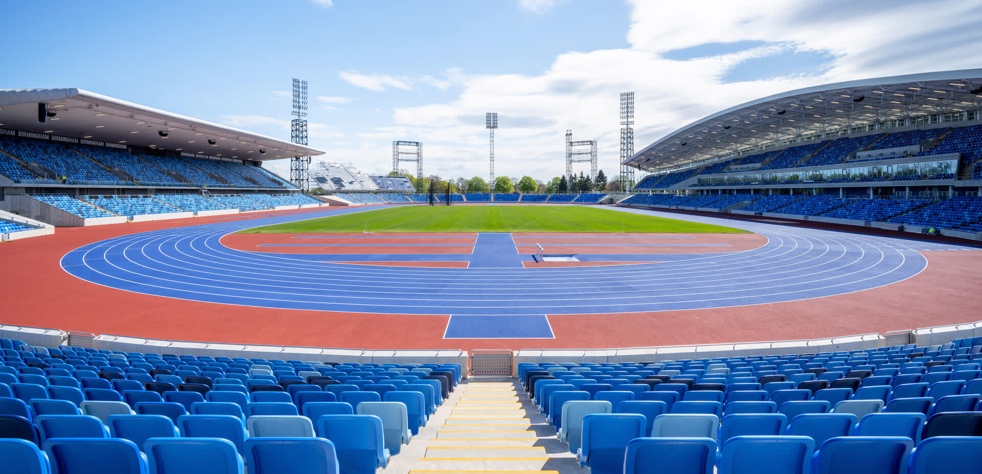 An expansive view of a large sport stadium with a running track in it.