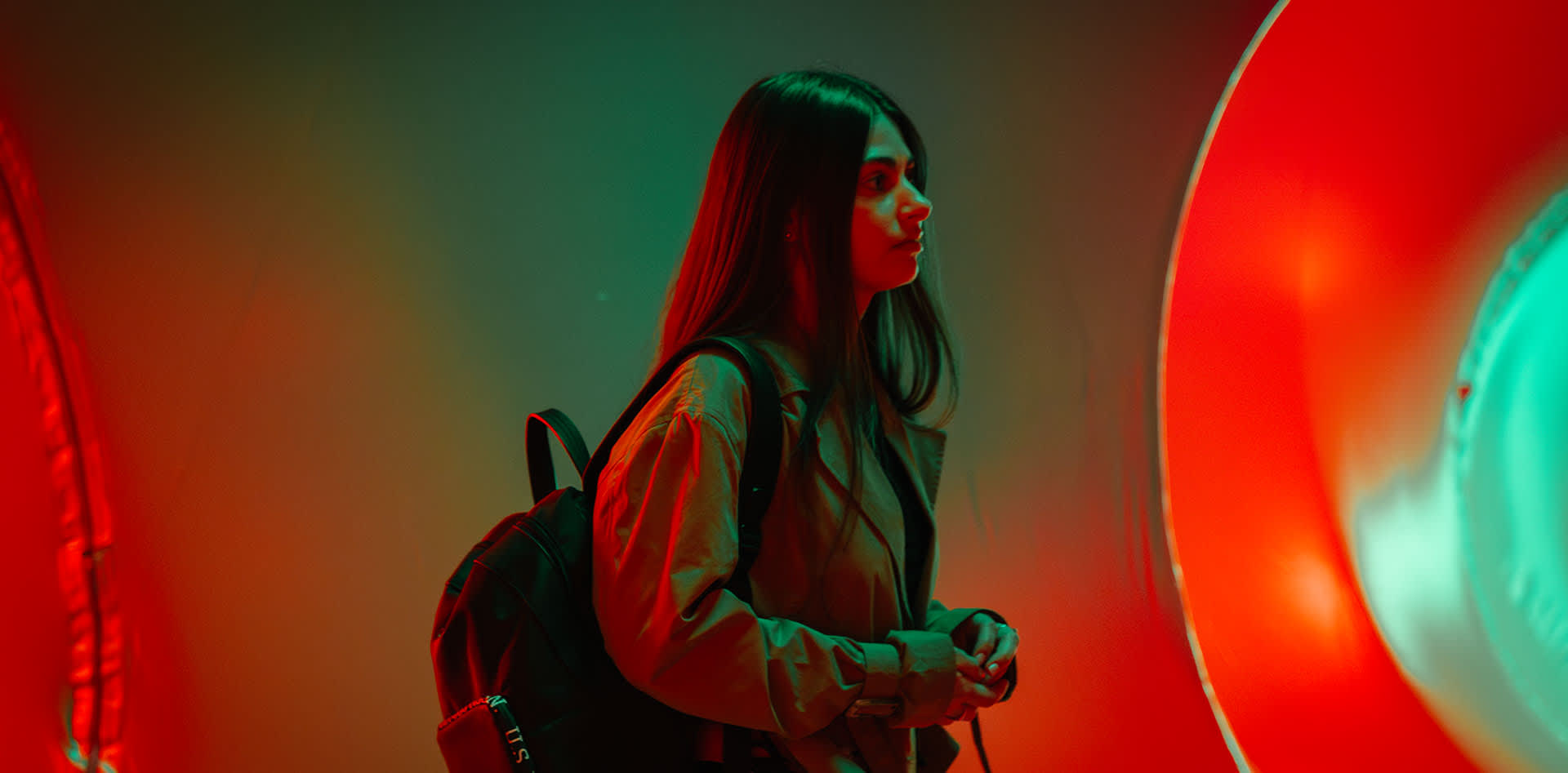 A girl walking through an arts installation