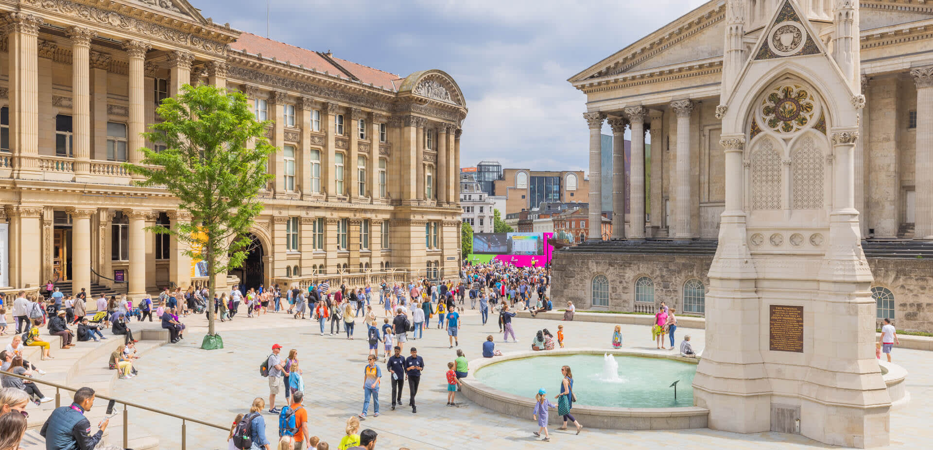 The clock tower, fountain and town house as seen from Paradise Birmingham, with a crowd gathered during the Commonwealth Games 2022