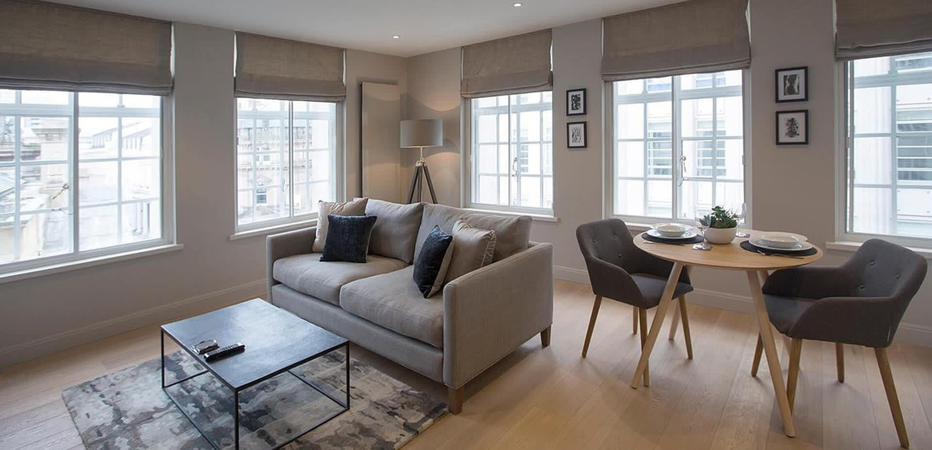 No.8 Waterloo St Apartments living room with sofa, dining table and two chairs