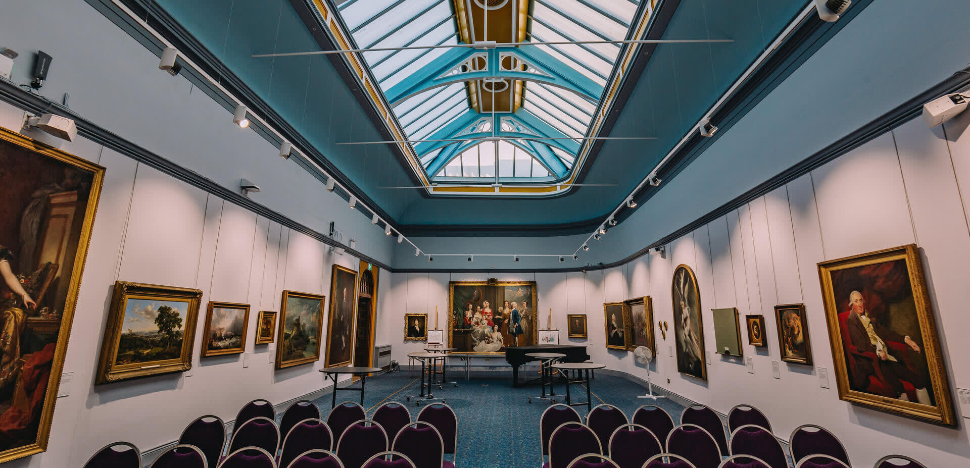 Portraits and paintings line the wall of Wolverhampton Art Gallery beneath an exquisite skylight