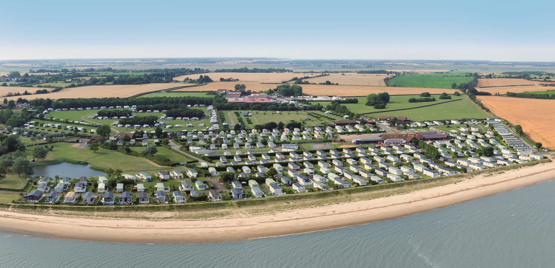 Aerial view of Waldegraves Holiday Park showing holiday homes by the beach