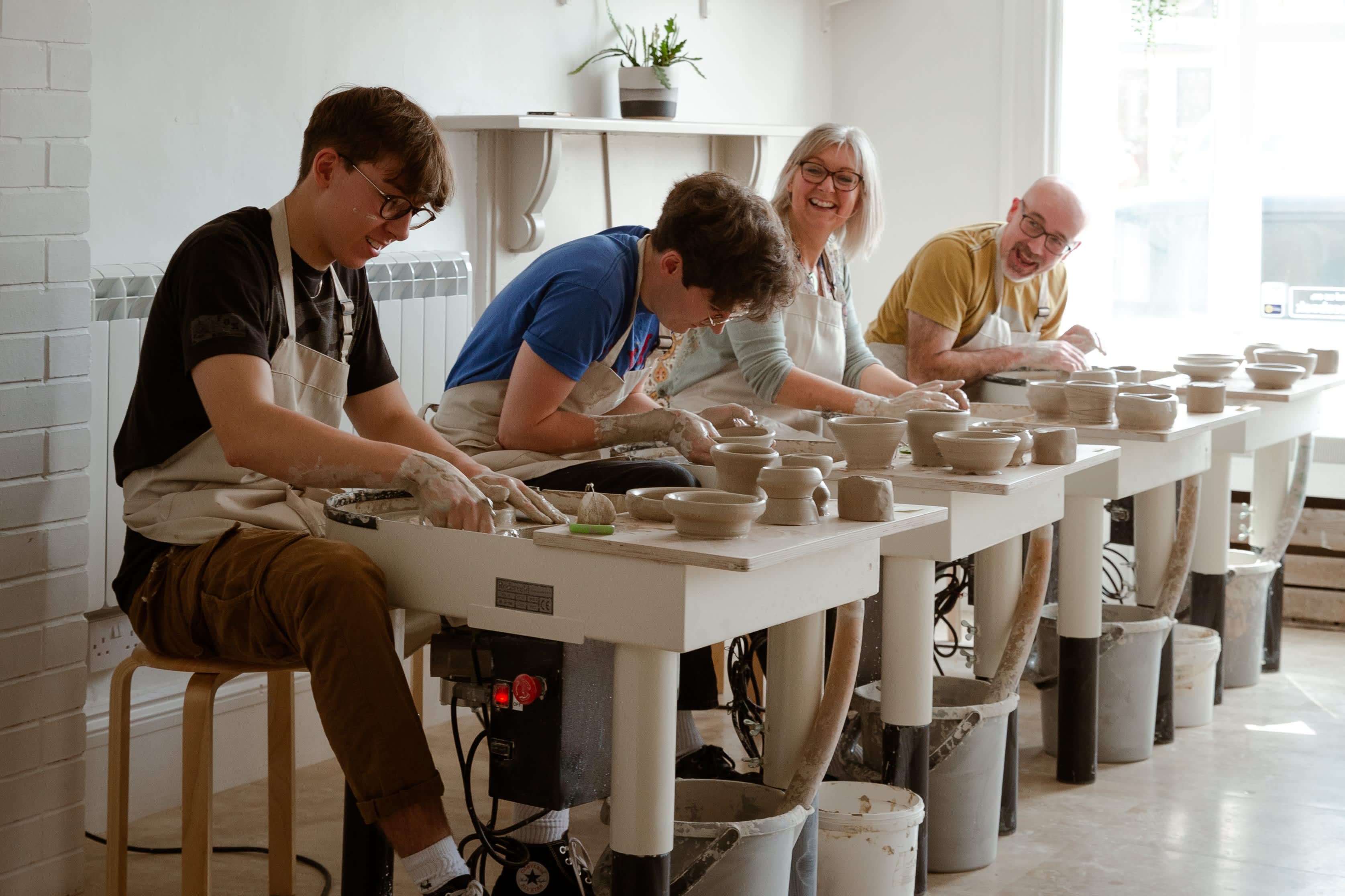A family enjoying a pottery class at Honeybourne Pottery