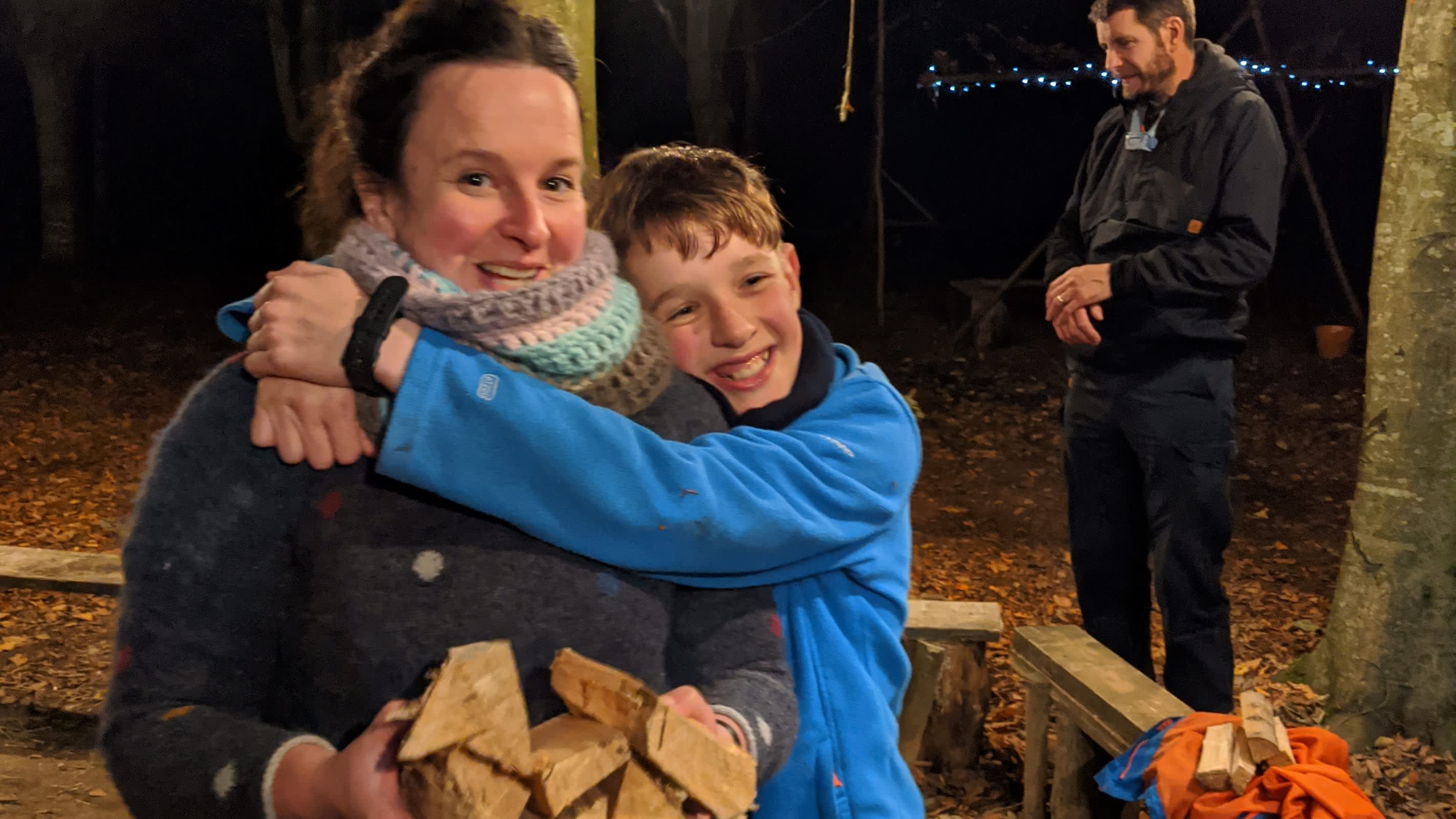 Mum and son by campfire