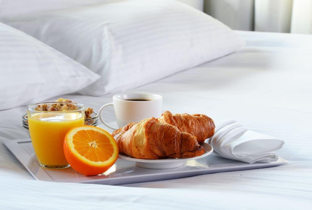 breakfast on a bed, white linen