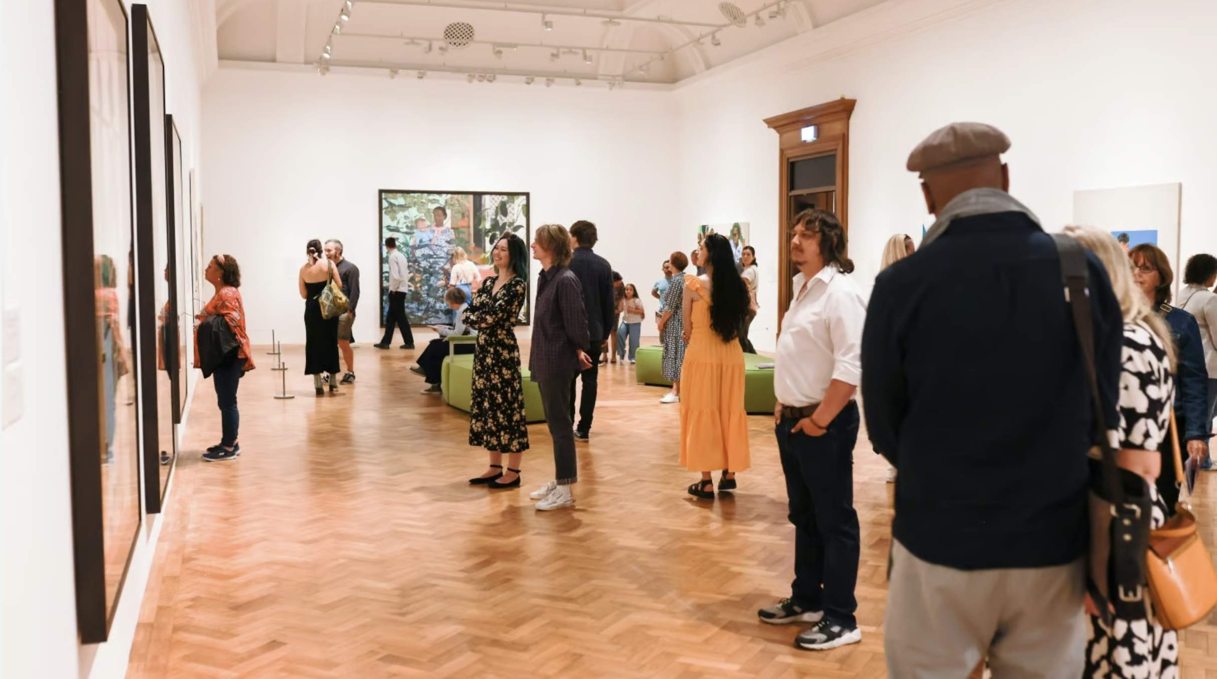 people in a gallery looking at paintings