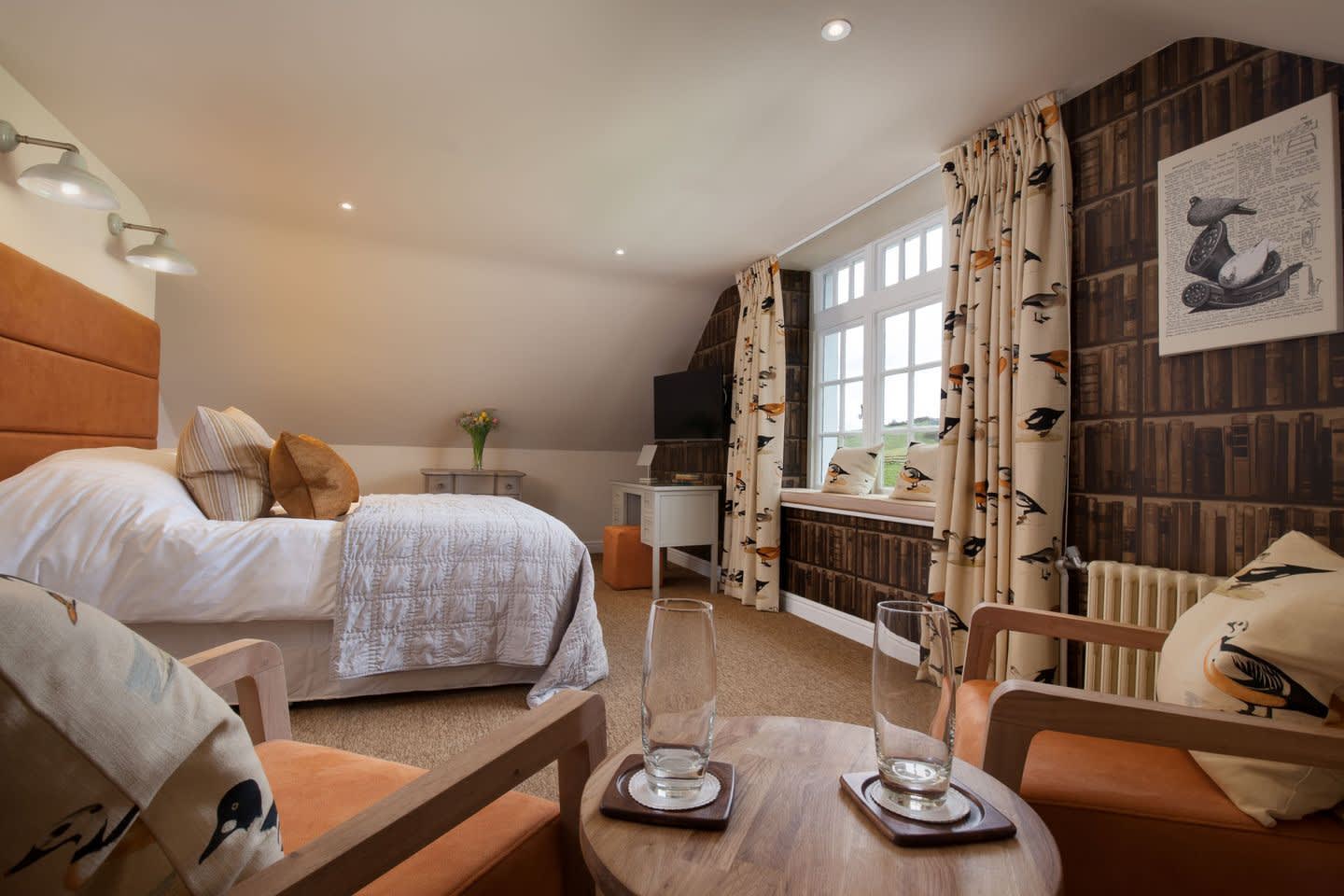 bedroom with double bed curtains and withe throw