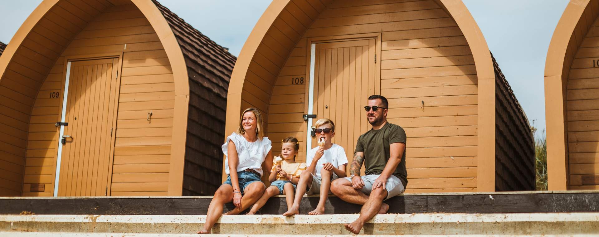 A family sat in front of the beach chalets in Bridlington, East Yorkshire enjoying an ice cream