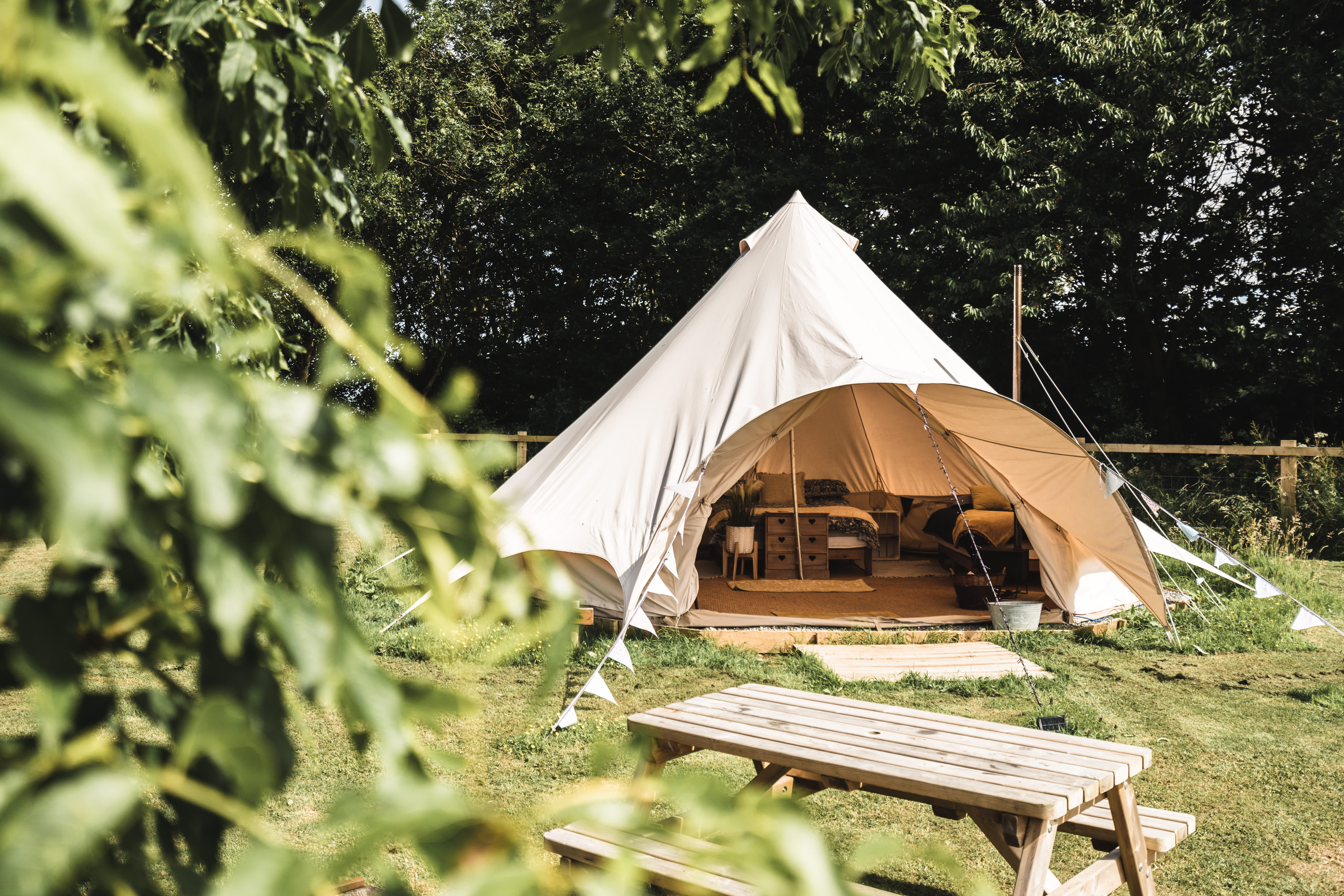 A bell tent amongst the greenery of Little Otchan Glamping in East Yorkshire