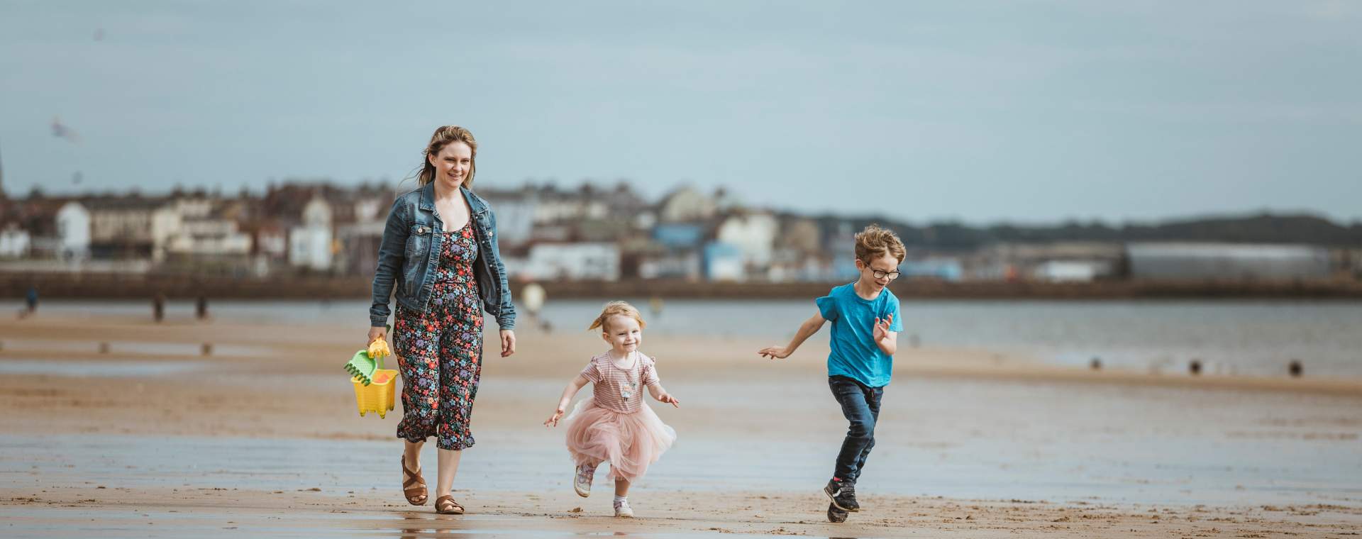 A family walking along Bridlington Beach in East Yorkshire