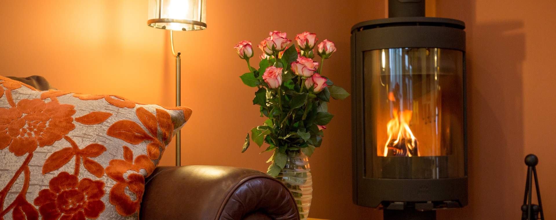 A cosy corner of a cottage with a warming log burner