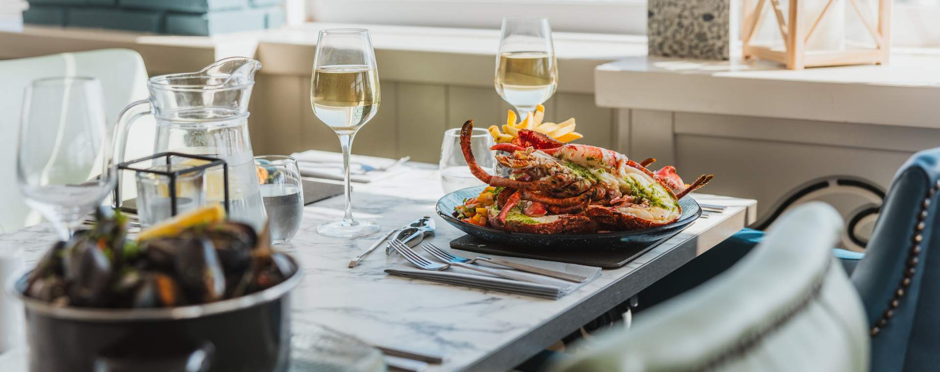 A plate of beautifully presented lobster alongside a pot of mussels ready to enjoy at Salt on the Harbour in Bridlington